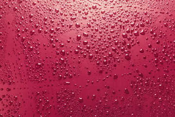 Red surface with shiny water drops, background