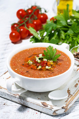 cold tomato soup in a bowl on white background, vertical