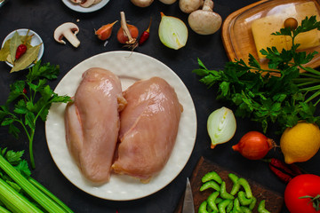 chicken breast, raw meat fillets and other ingredients (vegetables, celery, spices, mushrooms, microgreen). food background. copy space