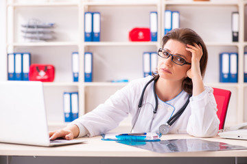 Aged female doctor working in the clinic 