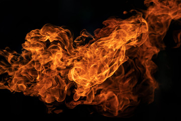 Closeup Fire flames from gas explosion on black background.