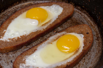 Two fried eggs in bread crust