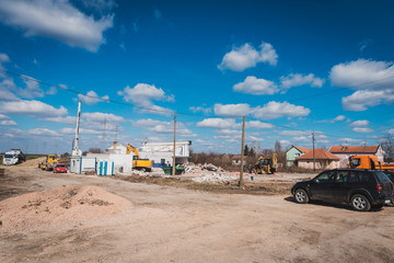 large construction machines are knocking down the houses on the construction site