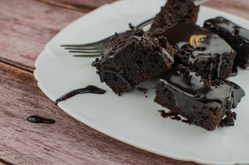 Sliced homemade brownies on white plate. Served on rectangle white plate. Favorite chocolate dessert for chocolate lover. Sweet and moist of cocoa taste. Top view.