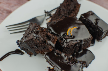 Sliced homemade brownies on white plate. Served on rectangle white plate. Favorite chocolate...