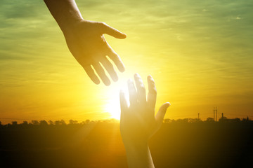 Man reaching for woman's hand at sunrise outdoors, closeup. Help concept