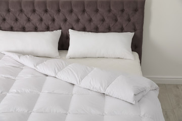Fototapeta na wymiar Comfortable bed with new mattress in room. Healthy sleep