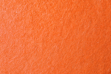 Texture of orange felt as background, closeup