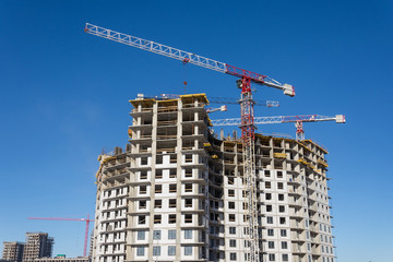Fototapeta na wymiar Crane and building construction site, look up view.