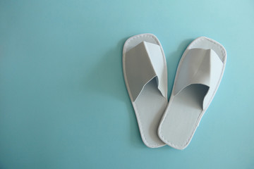 White Spa Slippers isolated on Light Blue Background