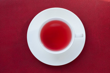 red drink in a white cup on a red background