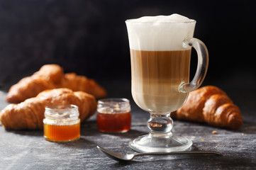 glass of latte coffee on dark table