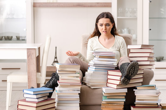 Young female student preparing for exams at home 
