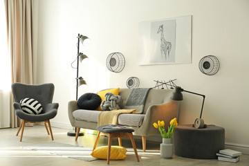 Stylish living room interior with comfortable sofa. Idea for home decor