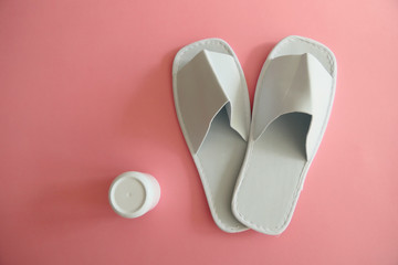 White Spa Slippers with a White Cream Box isolated on Pink Background