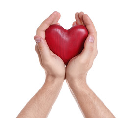 Obraz premium Man holding decorative heart in hands on white background, closeup