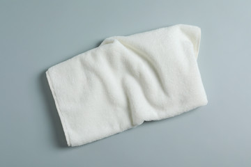 Soft towel on light background, top view