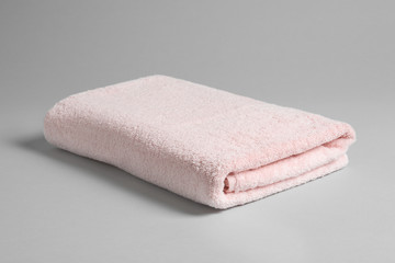 Fresh soft folded towel on light background
