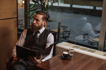 Bearded businessman with workbook