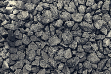 Background from a round dark gray stone. Dark pebbles closeup folded. Rectangular photo.