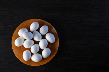 Easter eggs on the plate. festive meal on a dark wooden table