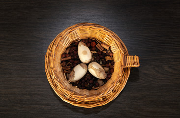 Easter eggs in the basket. wicker basket of straw. festive meal on a dark wooden table.