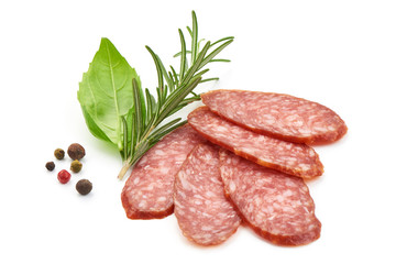Dried salami slices with herbs, close-up, isolated on white background