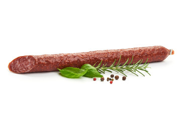 Fresh and dried sausage with herbs, close-up, isolated on white background