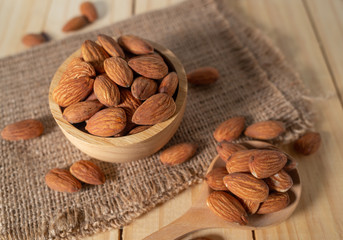 Almond snack fruit in wooden bowl on wooden