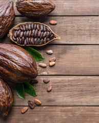 Cocoa pod and cocoa beans on the wooden table. Top view.