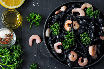Black pasta with shrimps. Black food. Food trend. Vegetarian lunch.