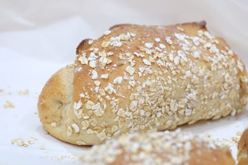 Close up a homemade bread on a white paper in a basket tray
