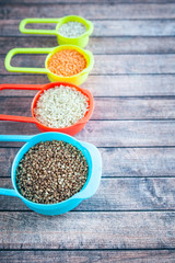 Collection of different cereals  in multi-colored containers, Oatmeal buckwheat, barley and rice