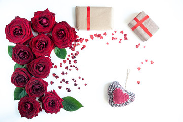 Flat Lay Background, flower pattern, Valentine's Day, the theme of lovers. Red roses and gifts with ribbons on a white background, isolated