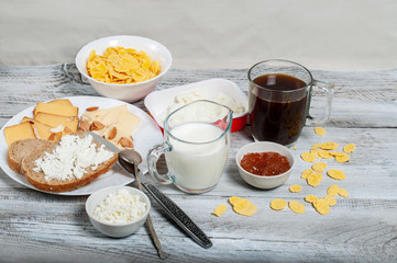 Healthy breakfast with cereal and feta cheese, a cup of coffee and sandwiches