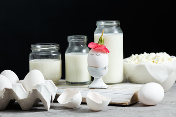 Fresh dairy and fermented milk products. Eggs On a black background.