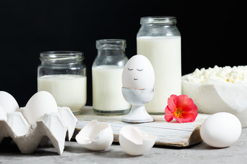 Fresh dairy and fermented milk products. Eggs On a black background.