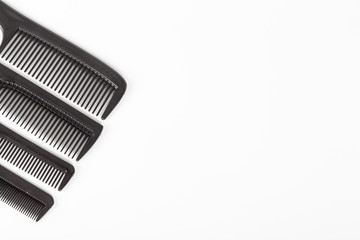 hair tools, beauty and hairdressing concept - different combs on white background