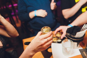 people with rum shots on party in club.
