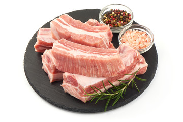 Fresh raw lamb meat ribs with rosemary and spices, close-up, isolated on white background