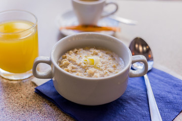 oatmeal on a blue background with orange juice and coffee