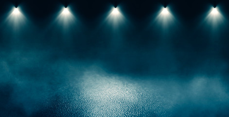Background of empty room with concrete pavement. Blue  neon light. Smoke, fog, wet asphalt with reflection of lights