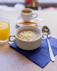 oatmeal on a blue background with orange juice and coffee