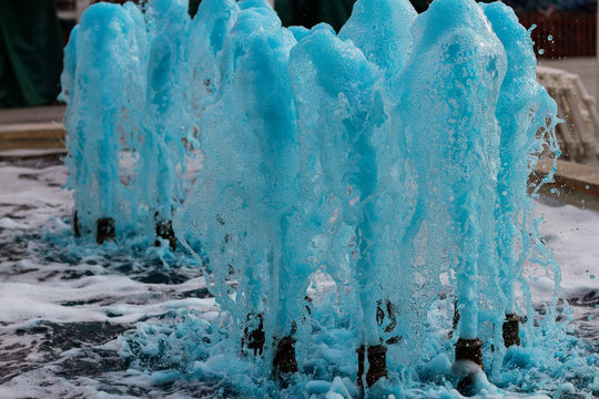 foreground in horizontal view of a source expelling blue water
