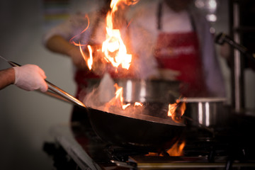 Chefs cooking in commercial kitchen