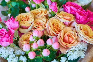 Beautiful bouquet of bright pink and beige roses.
