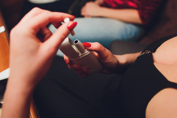 IQOS heat-not-burn tobacco product technology. Woman holding e-cigarette in his hand before smoking.