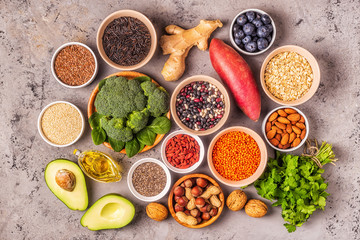 Superfoods on gray concrete background. Top view.