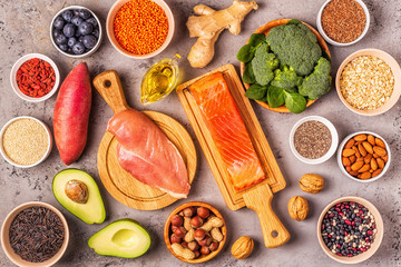 Superfoods on gray concrete background. Top view.