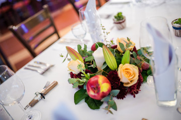 Beautiful table decoration with fresh flowers and accessoires